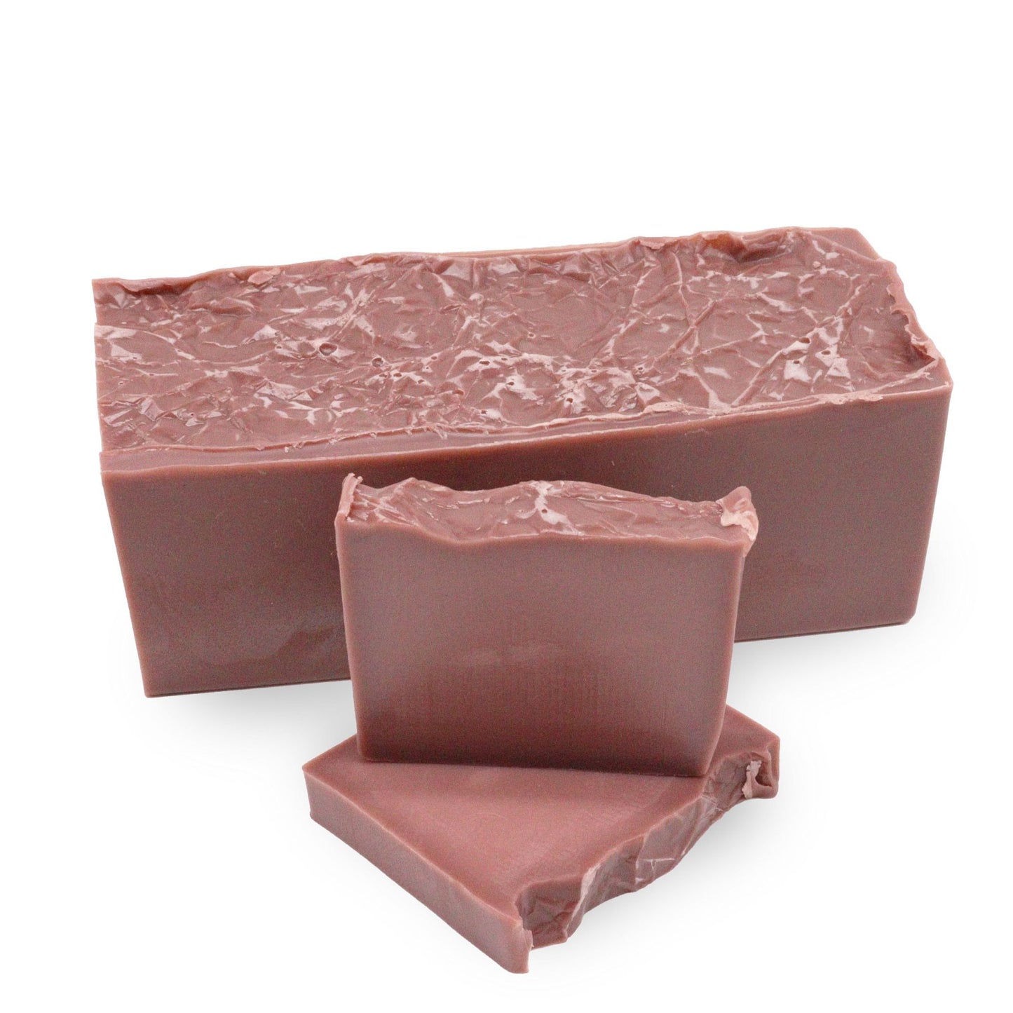 Handcrafted pink soap bar with a textured top, scented with raspberry and vanilla cupcake.