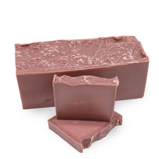 Handcrafted pink soap bar with a textured top, scented with raspberry and vanilla cupcake.