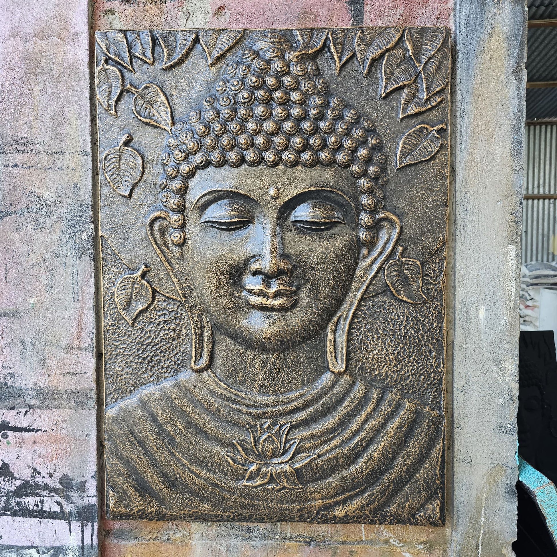 Large rectangular iron frame featuring a serene Buddha face in an antique gold relief finish.