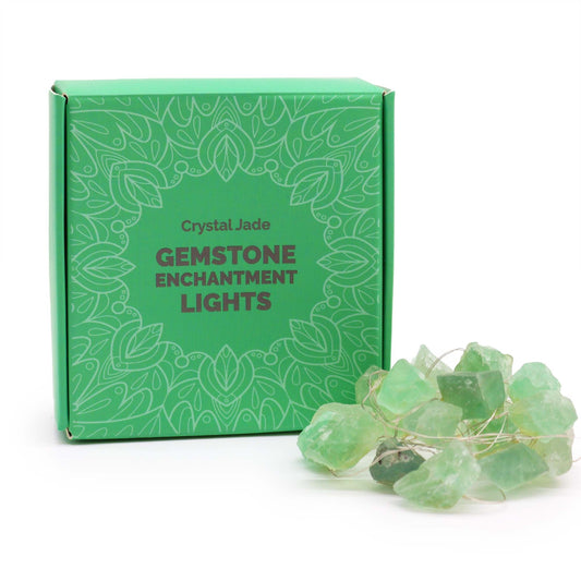 String of twenty green crystal jade gemstone rocks illuminated by warm LED lights creating a soft inviting glow.