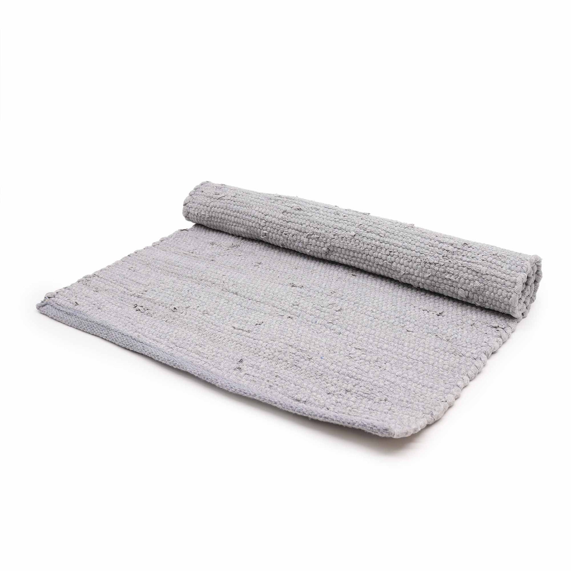 Close-up of a textured grey hand-loomed cotton rug with a classic woven pattern.