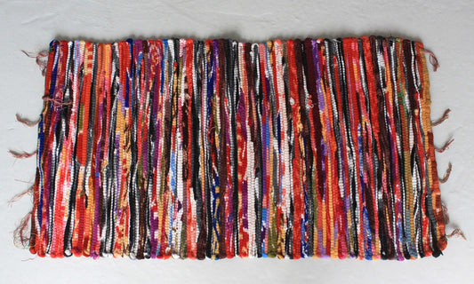 Small colourful handmade Indian rag rug made from recycled velvet and cotton textiles.