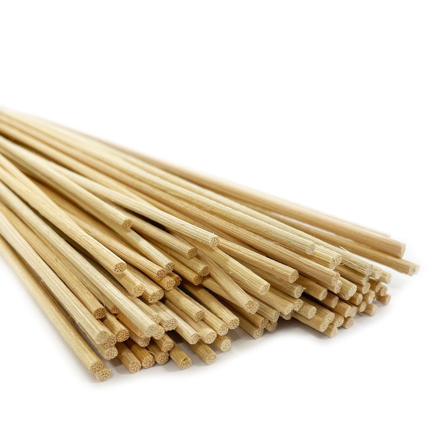 A large bundle of natural light brown rattan reed diffuser sticks tied together, ready for home fragrance use.