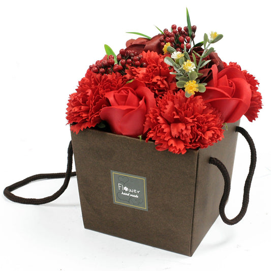 Beautifully arranged bouquet of realistic red rose and pink carnation luxury soap flowers in a decorative gift box.