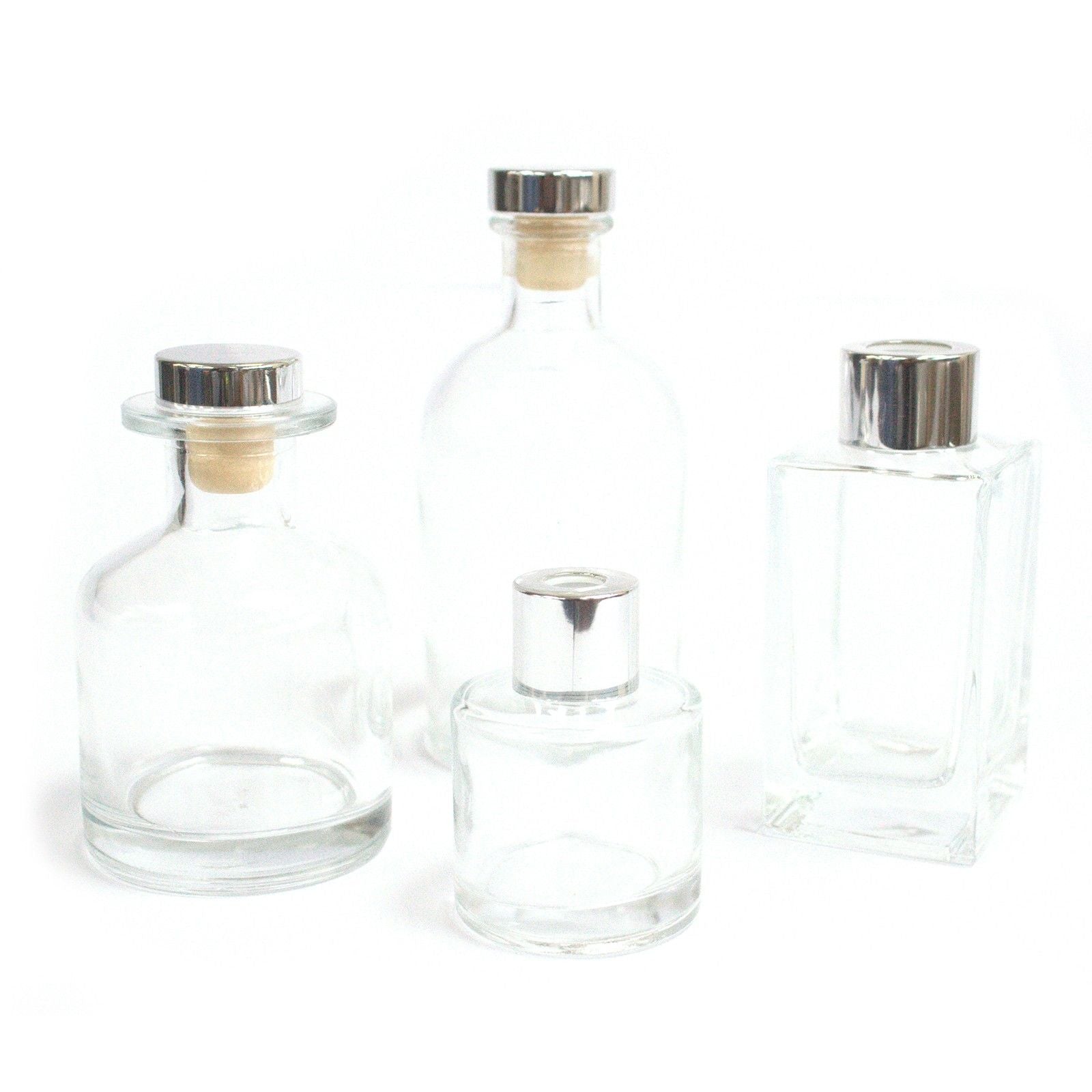 Clear round glass alchemist-style diffuser bottle for home aromatherapy and reed diffusers.