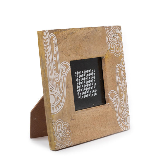 Square white mango wood picture frame with an intricate hand-carved floral Hansa pattern and a rustic finish.