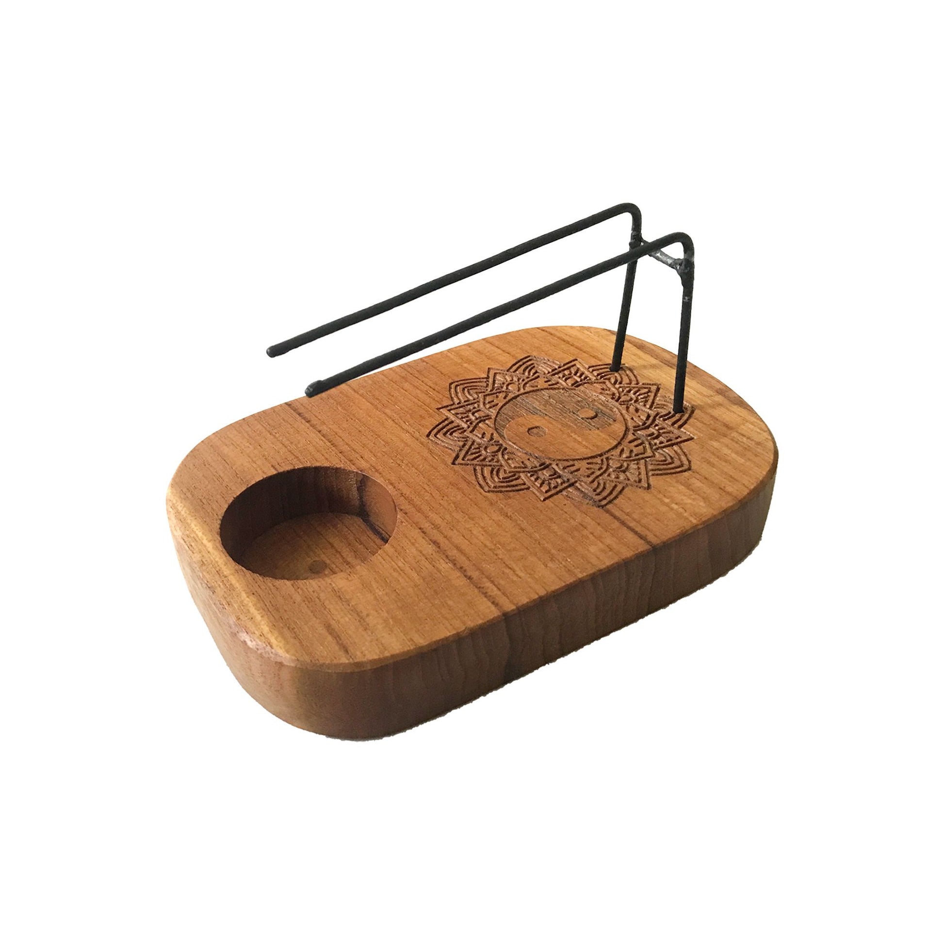 Handcrafted teak wood Palo Santo heater featuring an intricate Yin and Yang design with a natural wood finish.