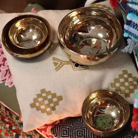 Large polished gold-tone bell-metal singing bowl with a handcrafted finish and smooth rounded edges.