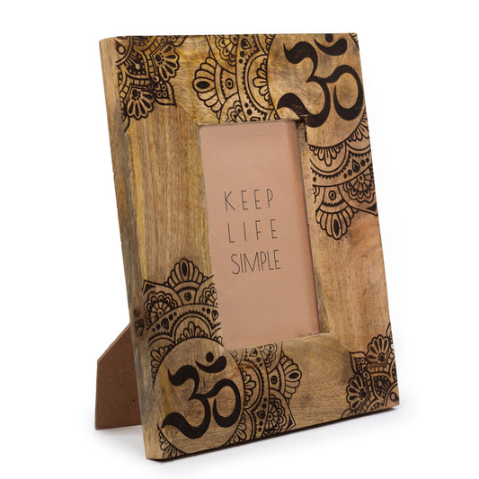 Hand-carved black mango wood picture frame featuring a detailed circular mandala pattern and natural wood grain texture.