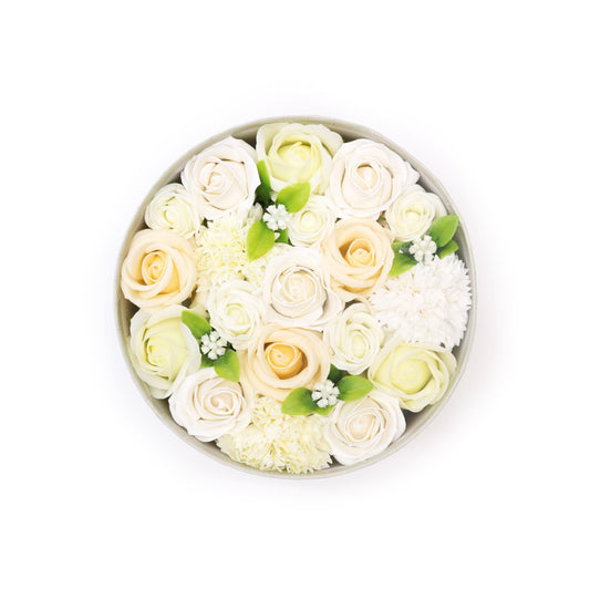 Elegant round gift box filled with realistic white and ivory soap flower roses and petals.