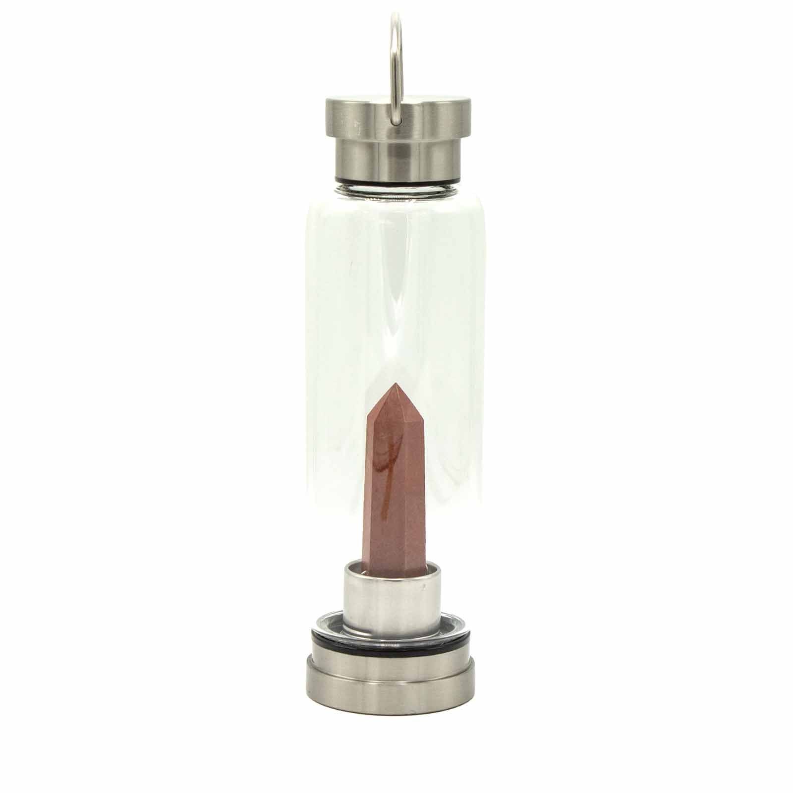 Sleek glass water bottle featuring a vibrant red jasper crystal obelisk inside and a silver-toned lid and base.