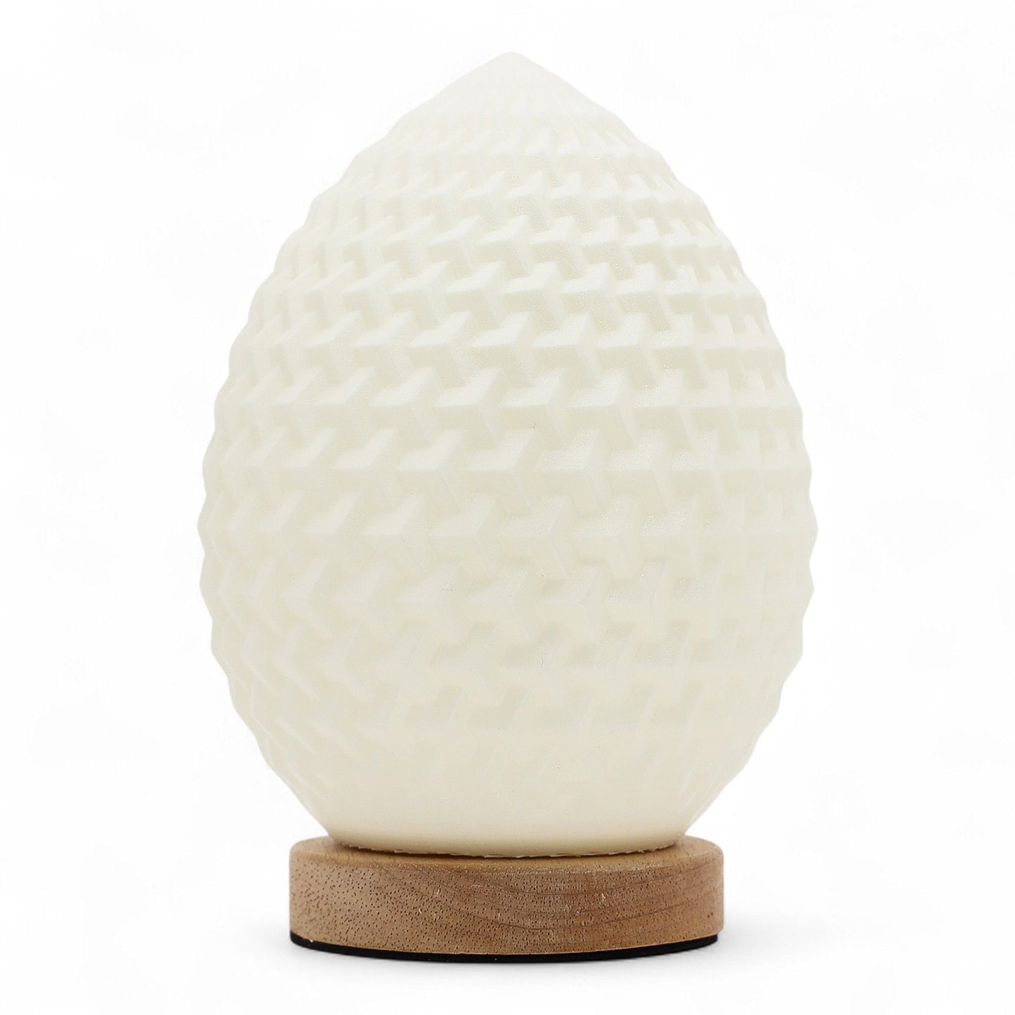 Modern teardrop-shaped lamp with a white honeycomb textured surface emitting a soft ambient glow.