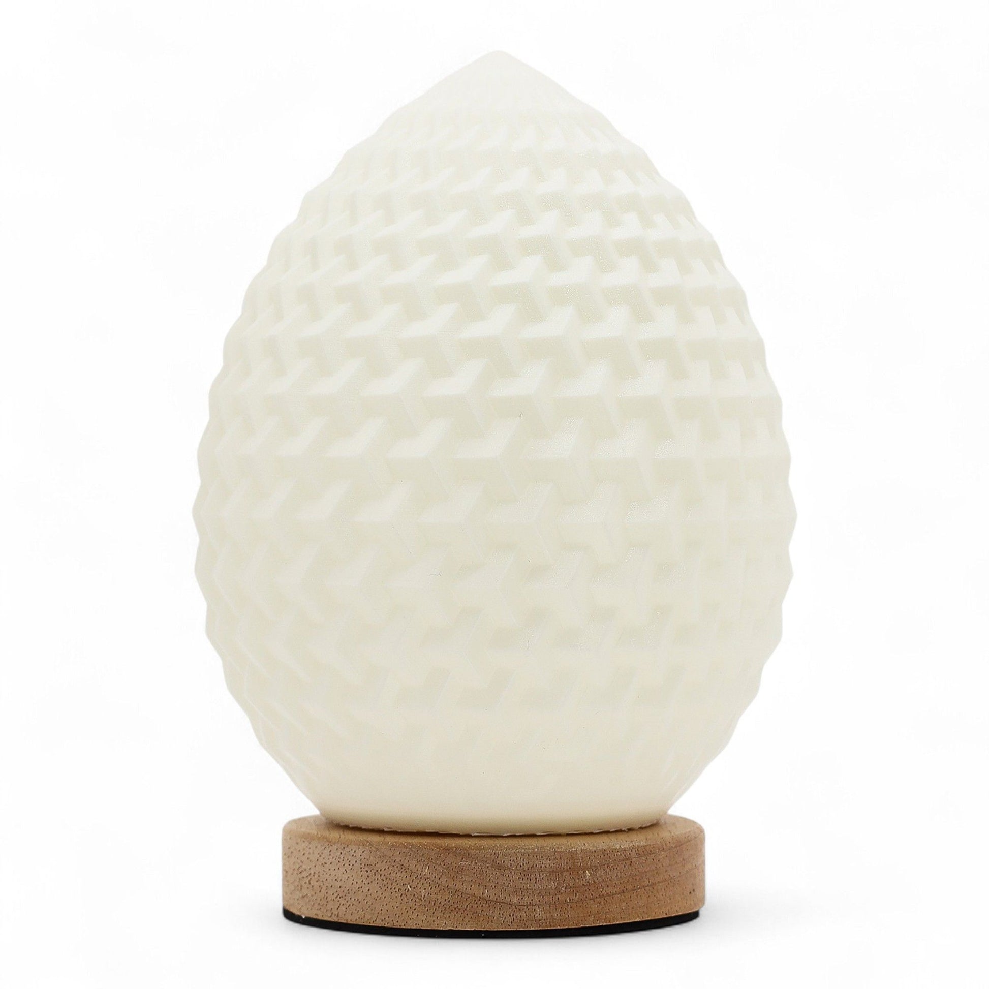 Modern teardrop-shaped lamp with a white honeycomb textured surface emitting a soft ambient glow.