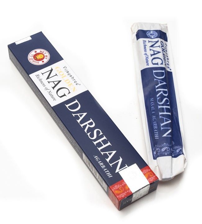 Golden Nag Darshan incense box with hand-rolled masala incense sticks displayed on a wooden surface.