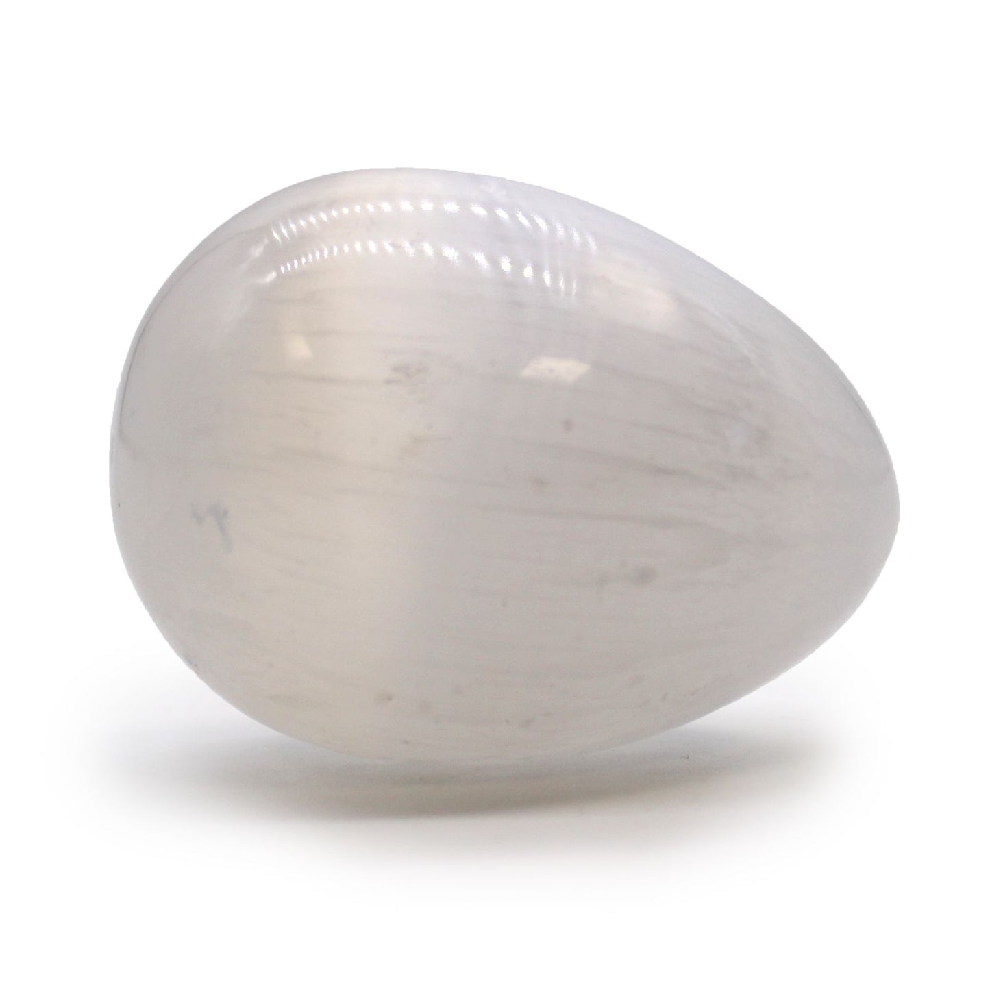 Smooth, egg-shaped white selenite crystal with a milky, iridescent finish reflecting light.