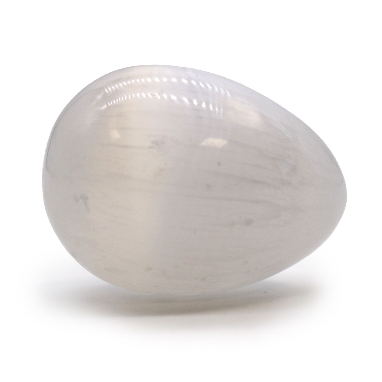 Smooth, egg-shaped white selenite crystal with a milky, iridescent finish reflecting light.