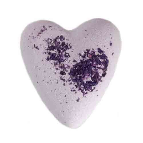 Large heart-shaped purple bath bomb topped with fine cosmetic glitter for a luxurious self-care ritual.