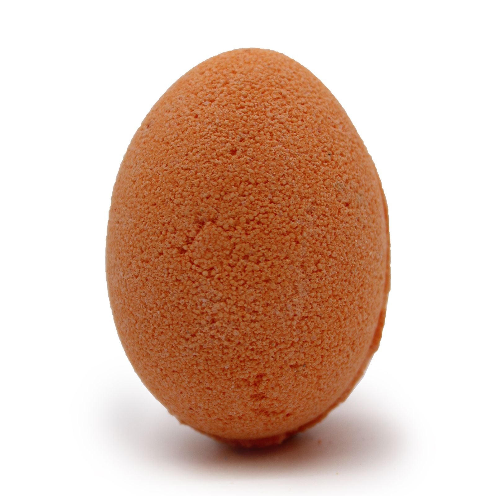 Tray of vibrant orange and yellow egg-shaped bath bombs with a smooth texture.