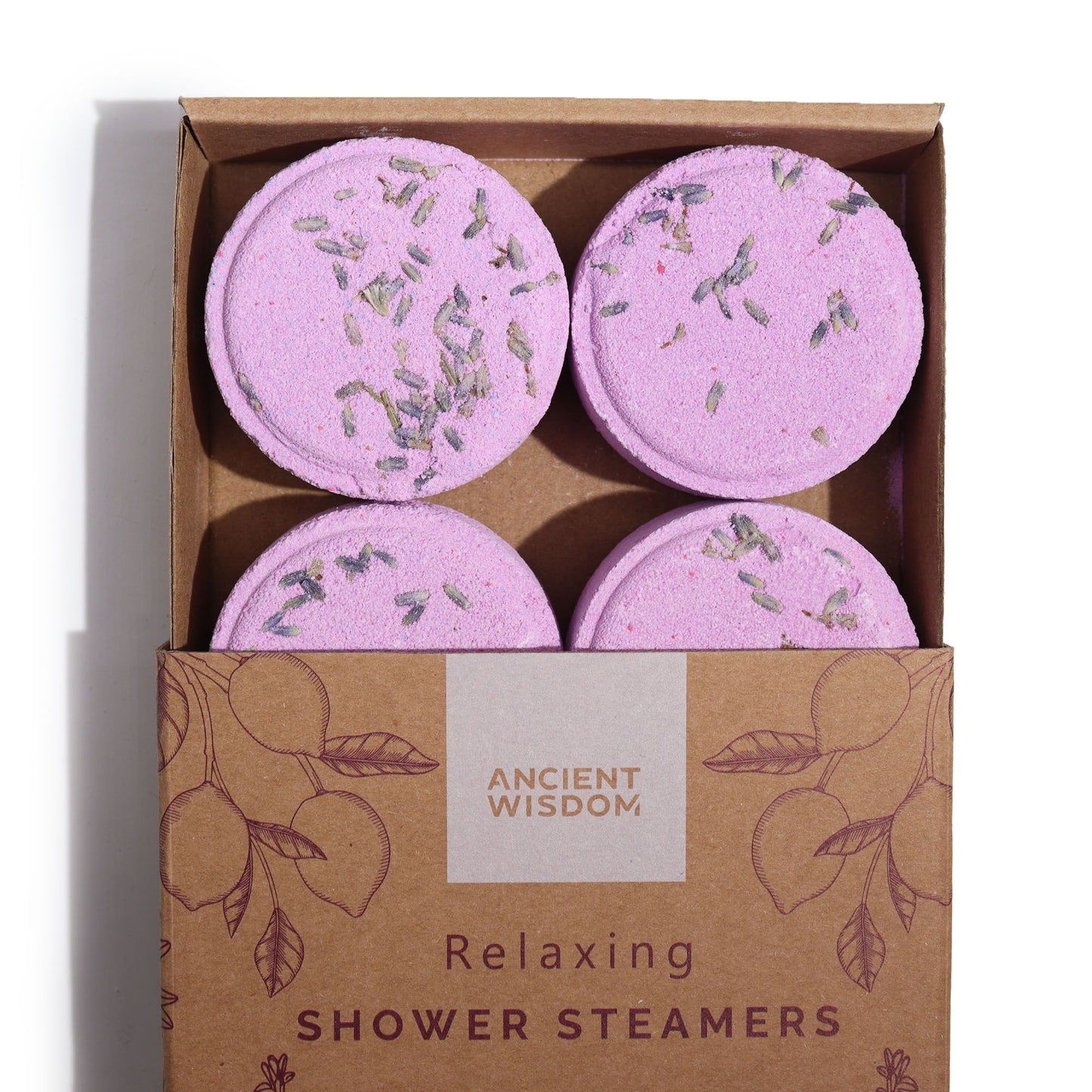 A set of four circular white aromatherapy shower steamers topped with dried lavender seeds in a gift box.