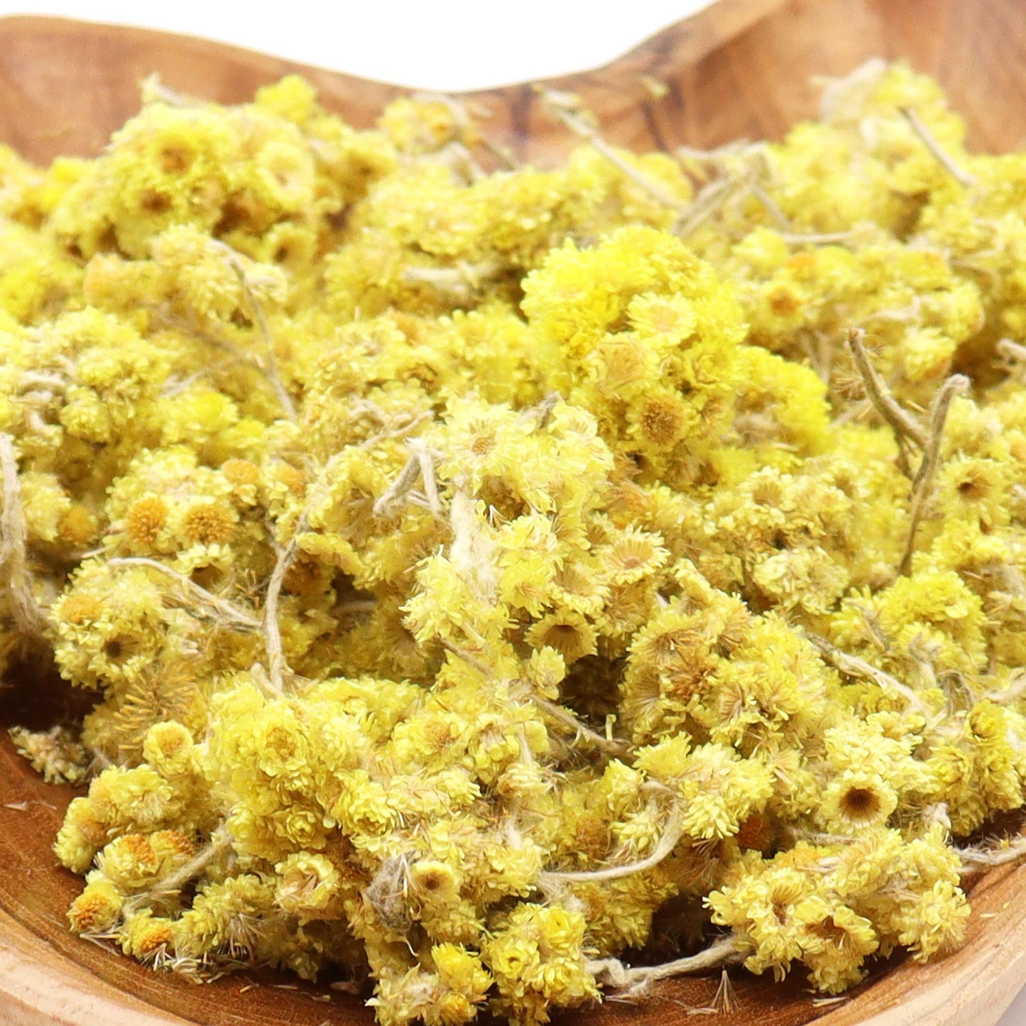 Large bundle of colourful dried everlasting flowers in a natural floral arrangement.