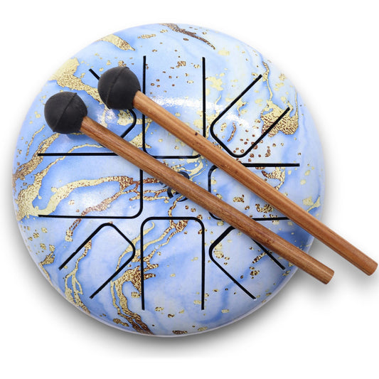 A medium-sized steel tongue drum in a vibrant blue sky finish with precisely cut tongues on top.