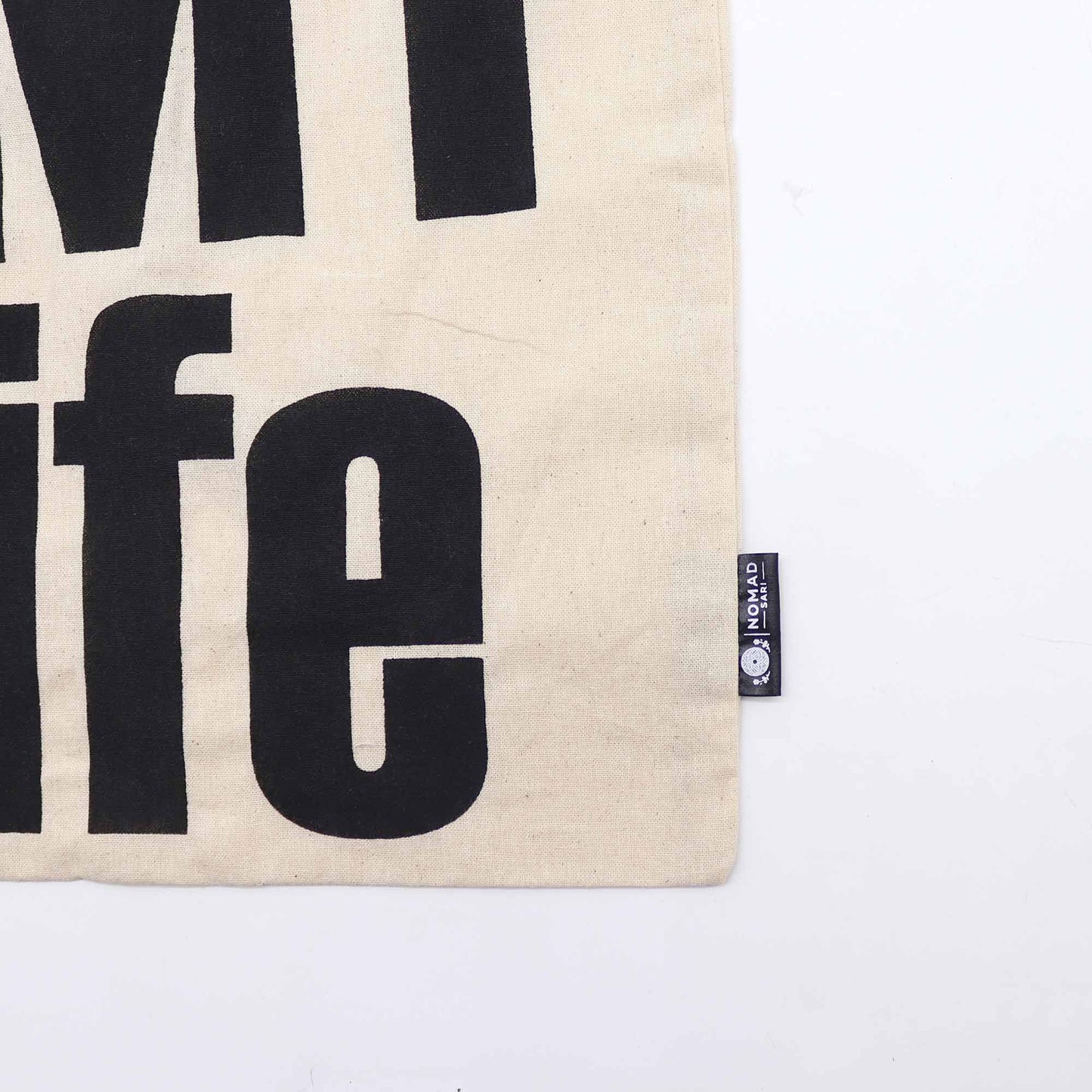 Minimalist natural cotton tote bag with It's My Life text in a simple black font.