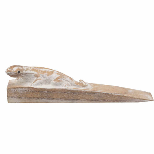 Close-up of a hand-carved wooden doorstop featuring a detailed gecko lizard climbing the wedge.