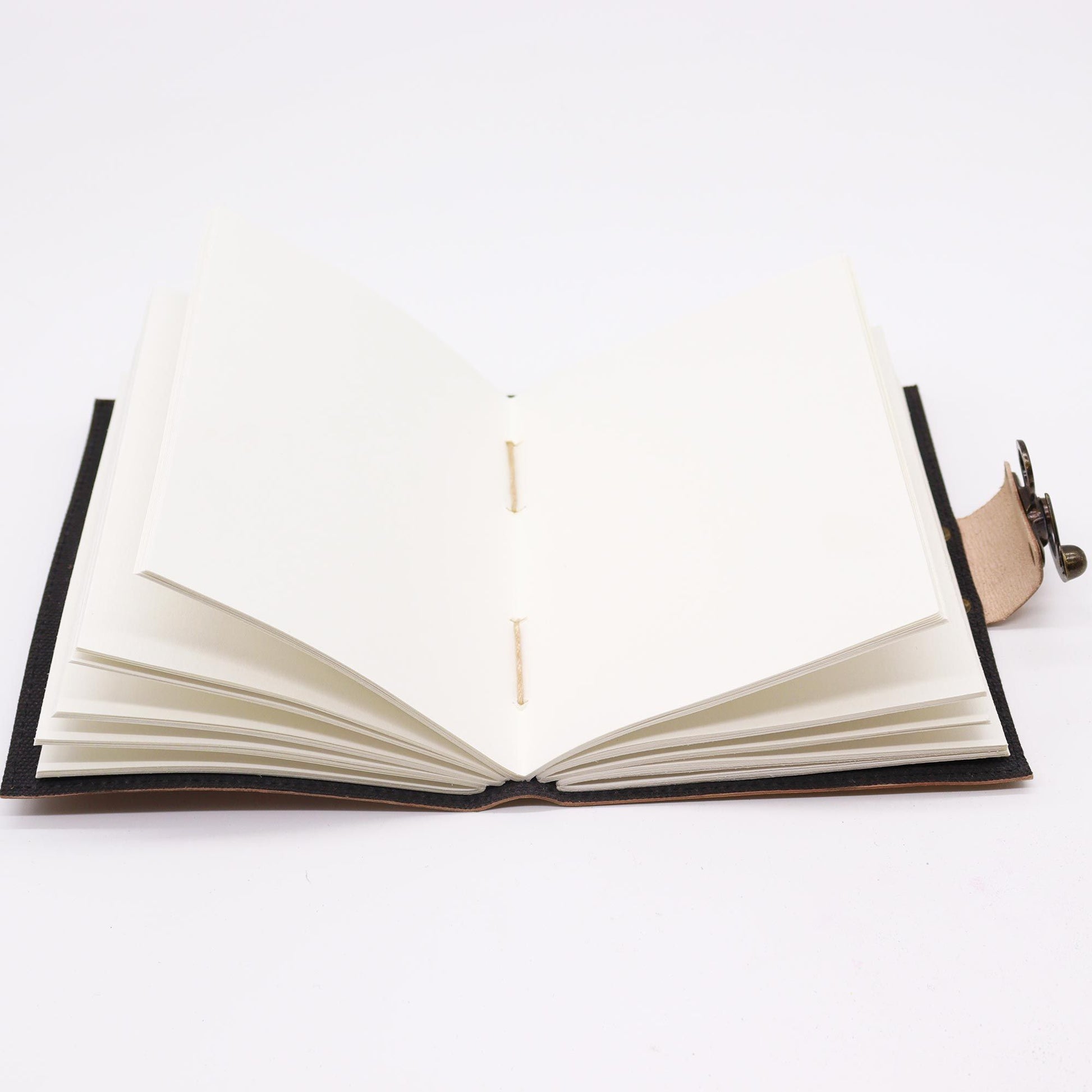 Handcrafted tan leather notebook featuring an embossed motivational message and a vintage-style metal clasp.