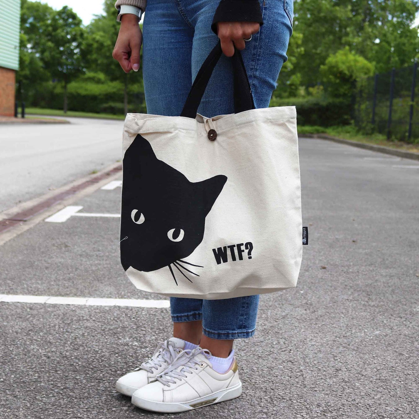 Natural cream-coloured 10oz cotton tote bag featuring a minimalist black cat graphic on the front.
