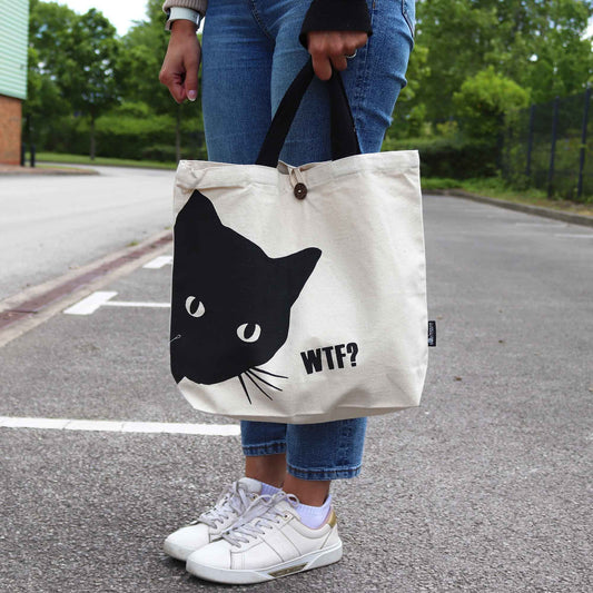 Natural cream-coloured 10oz cotton tote bag featuring a minimalist black cat graphic on the front.