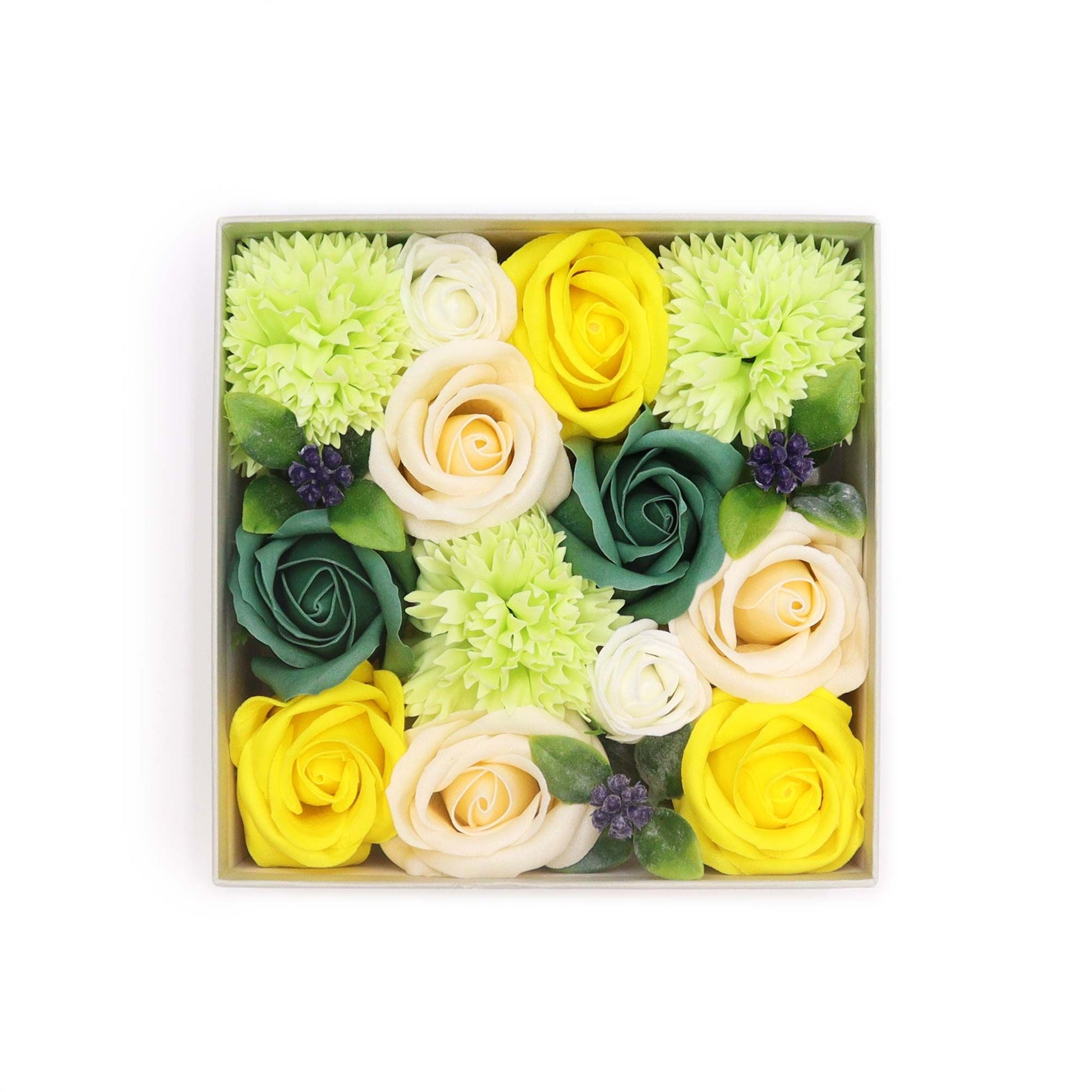 Square gift box filled with realistic yellow and green soap flowers arranged in a spring-themed bouquet.