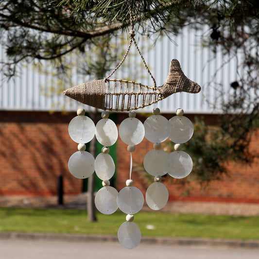 Handcrafted driftwood chime featuring string fish and iridescent natural capiz shell drops.