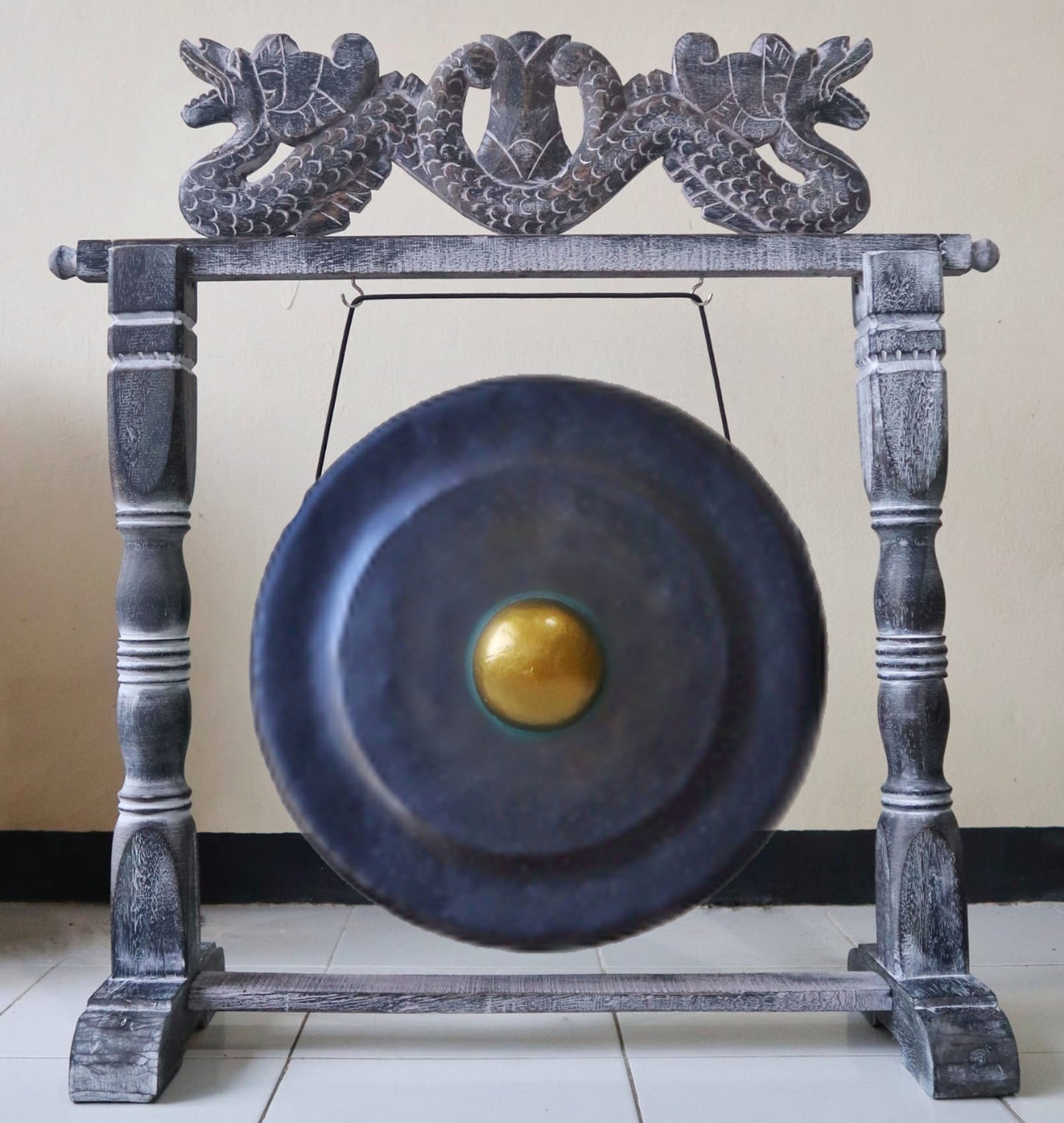 Handcrafted medium-sized black healing gong suspended in a sturdy black wooden minimalist stand.