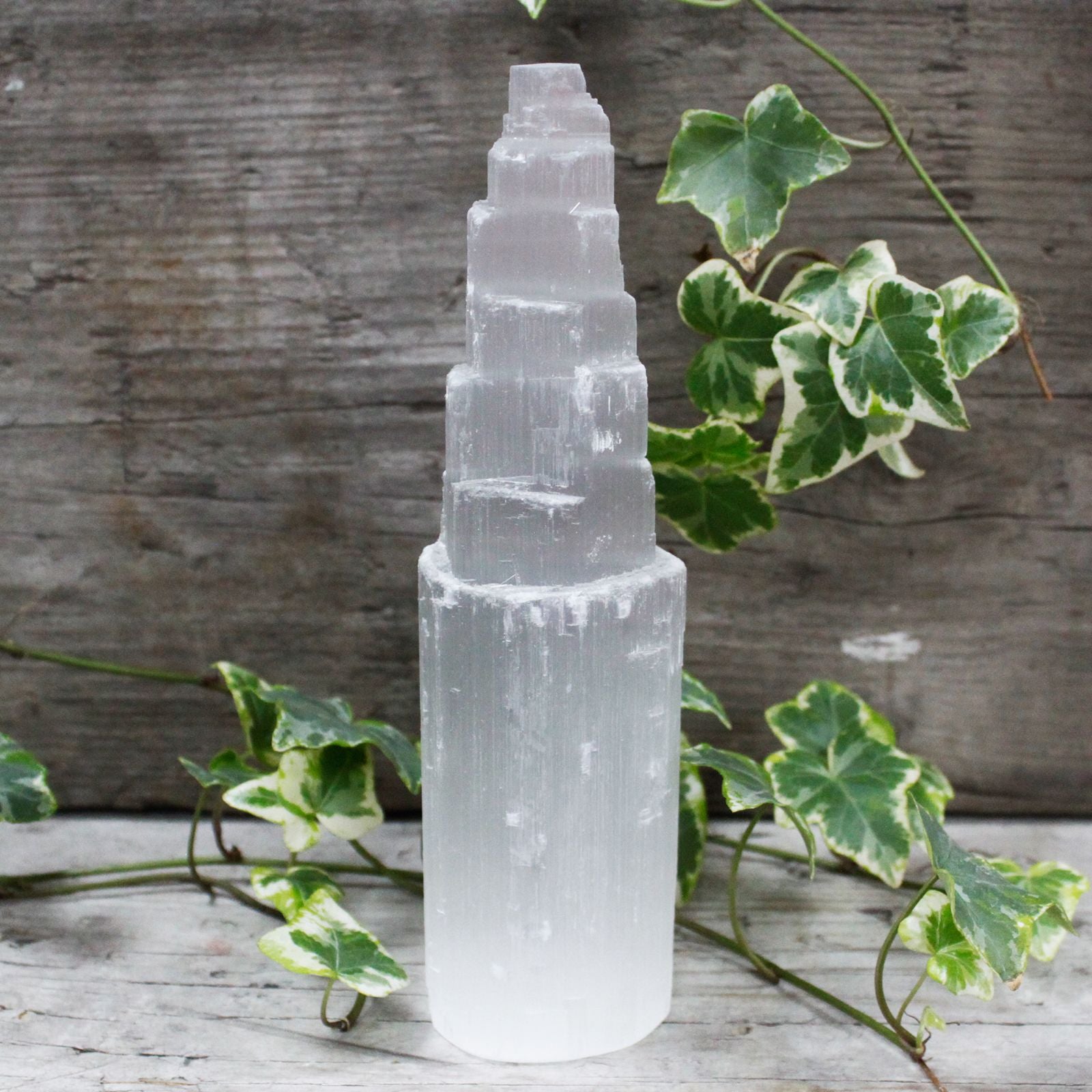 Tall white crystalline selenite tower with a natural pointed shape and characteristic milky translucent texture.