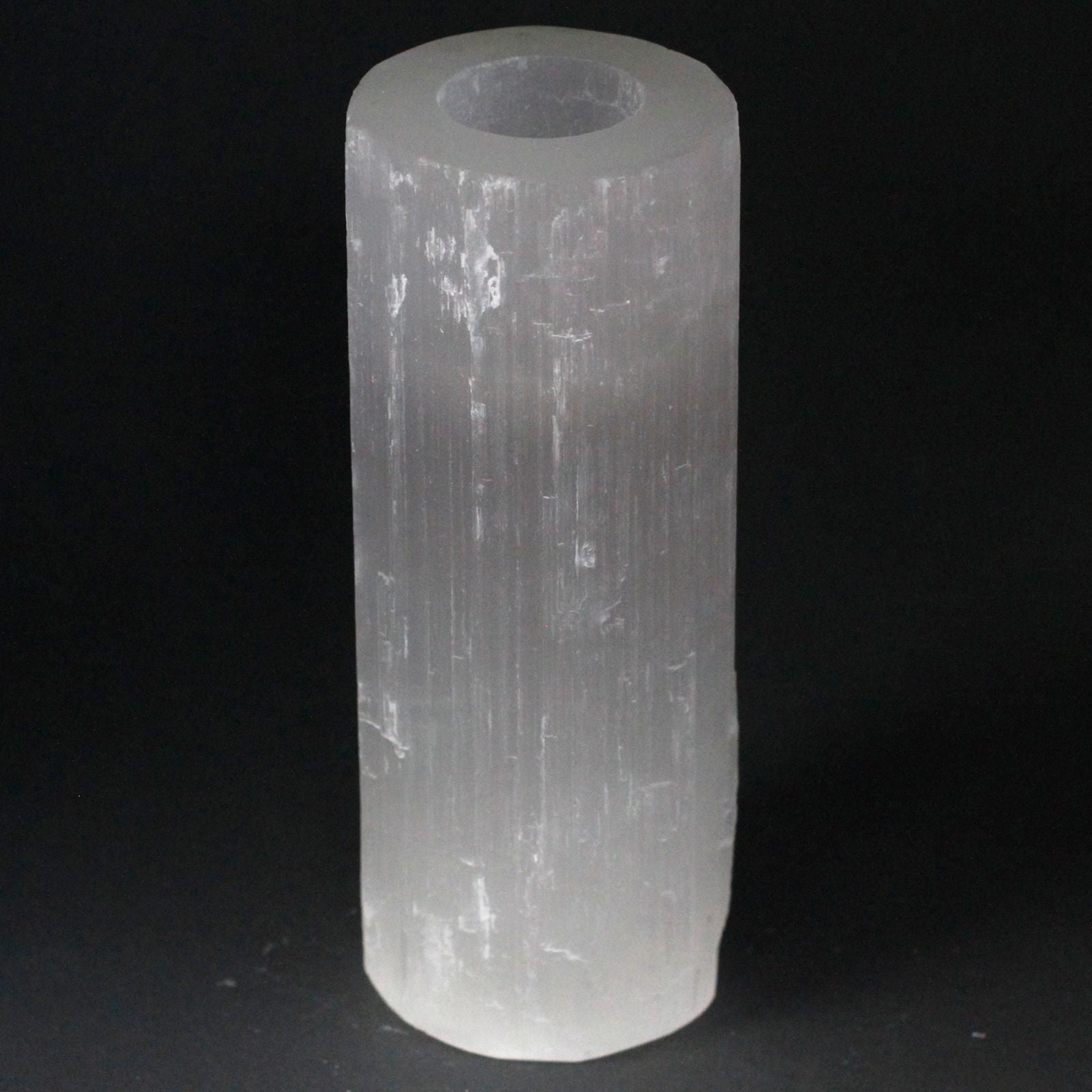 Tall translucent white selenite cylinder candle holder with natural rough edges and a smooth polished finish.