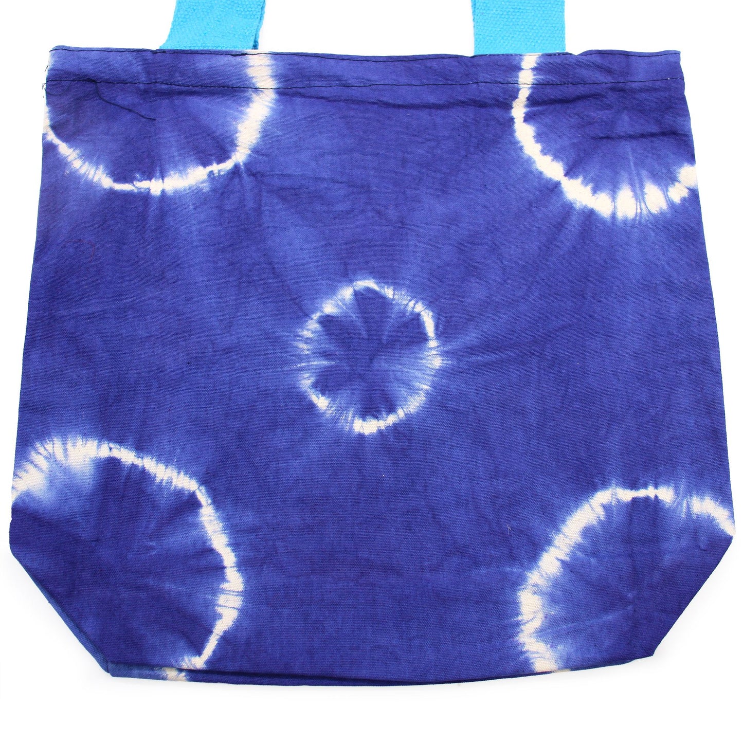 Handmade natural cotton tote bag featuring a unique blue ring tie-dye pattern and vibrant blue handles.