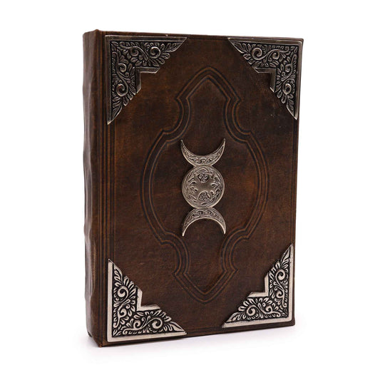 Hefty brown tan leather notebook with a decorative zinc triple moon symbol and textured deckle edge pages.