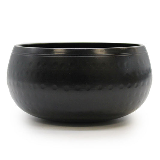 A 15cm medium black beaten metal Tibetan singing bowl with a textured surface and traditional circular base.