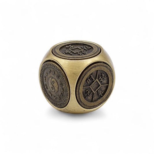 Small square metal spinner shaped like a dice with detailed traditional zodiac and Feng Shui symbols on each side.