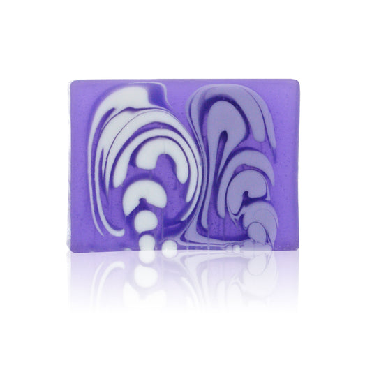 A single slice of handcrafted purple lavender soap showing a natural, textured surface.