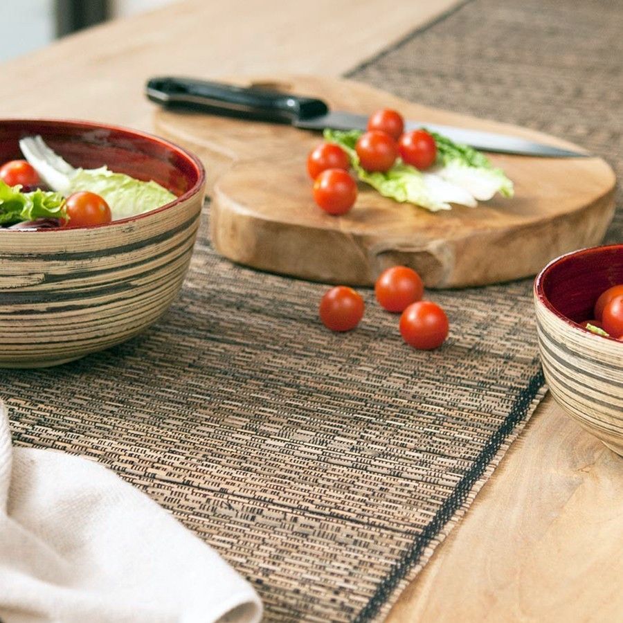 Round hand carved teak wood chopping board showing natural wood grain and rich brown tones.