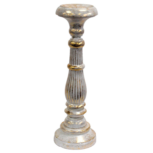 Large hand-carved wooden candlestick with an ornate white and gold finish, designed to hold church candles.