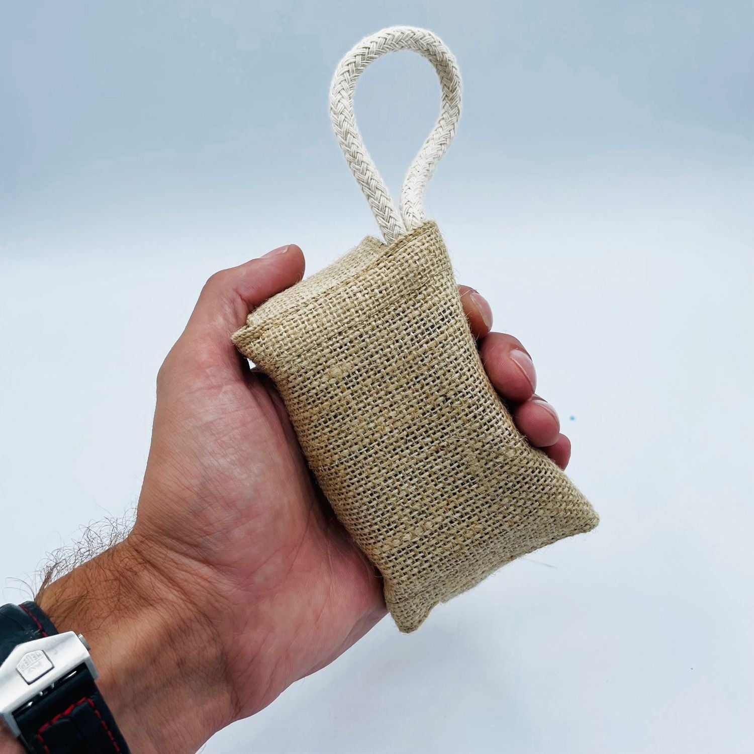 Textured natural jute soap saver pouch with a drawstring closure for exfoliation.