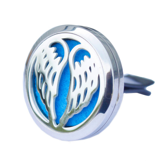 Round silver aromatherapy car locket with an intricate angel wing cutout design and a clip for a car vent.