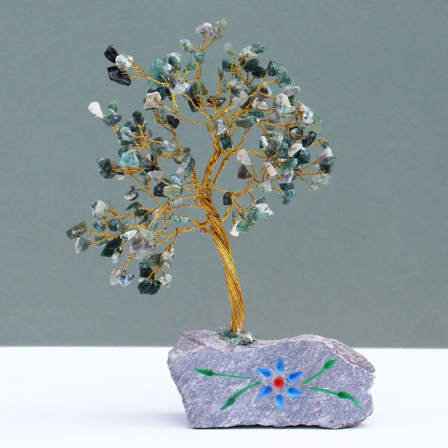 Handmade gemstone tree featuring 160 green Moss Agate stones on flexible wire branches with a natural rock base.
