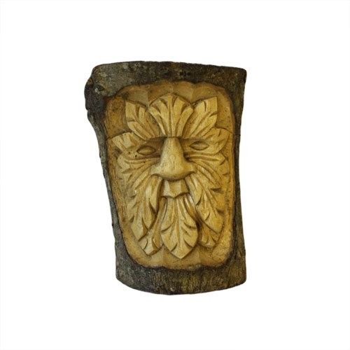 Hand-carved wooden tree stump sculpture featuring a detailed Green Man face with leafy features.