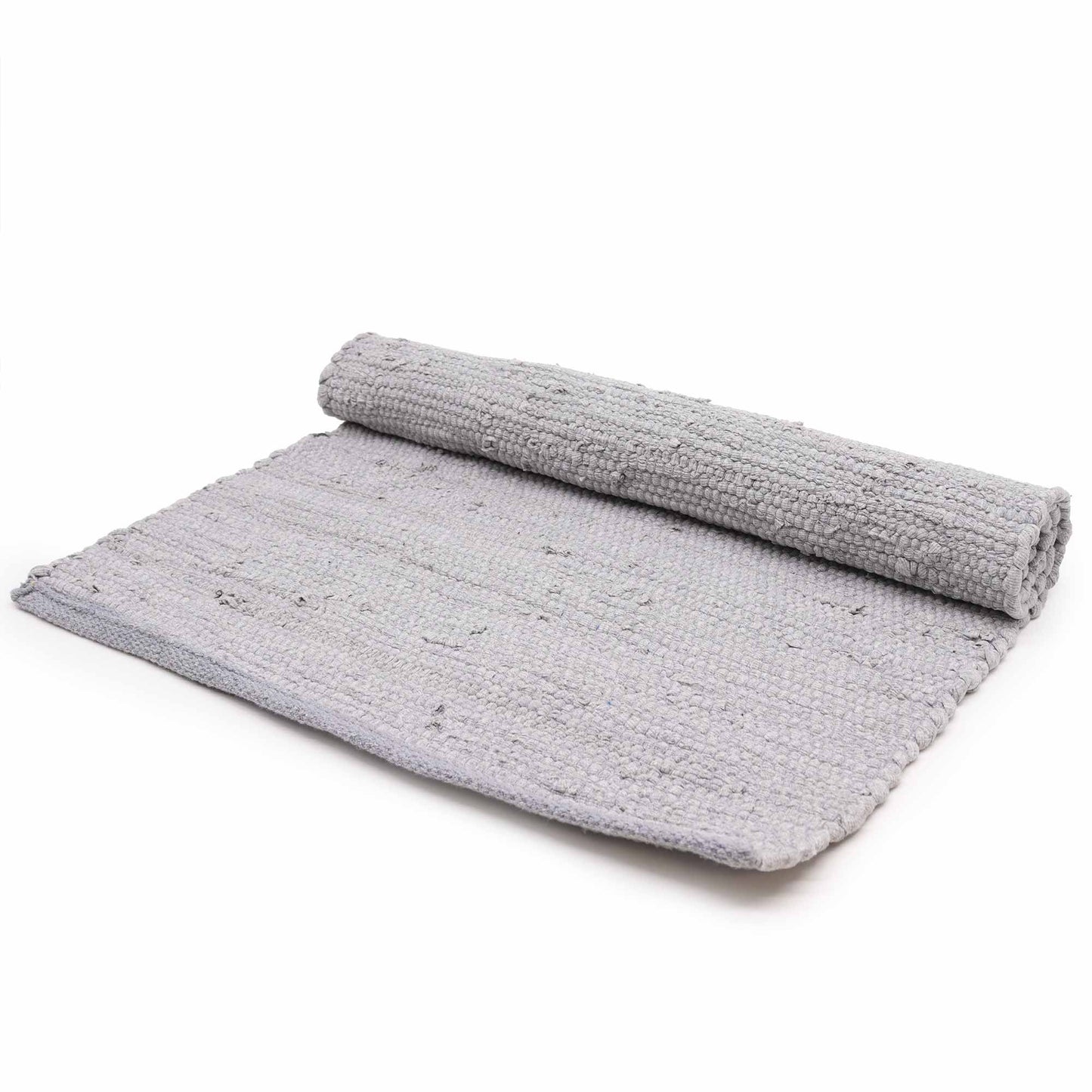 Large handloomed grey cotton rug with a textured weave and fringe detail on a wooden floor.