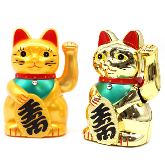Classic gold Maneki Neko lucky waving cat figurine with a moving left paw on a red base.