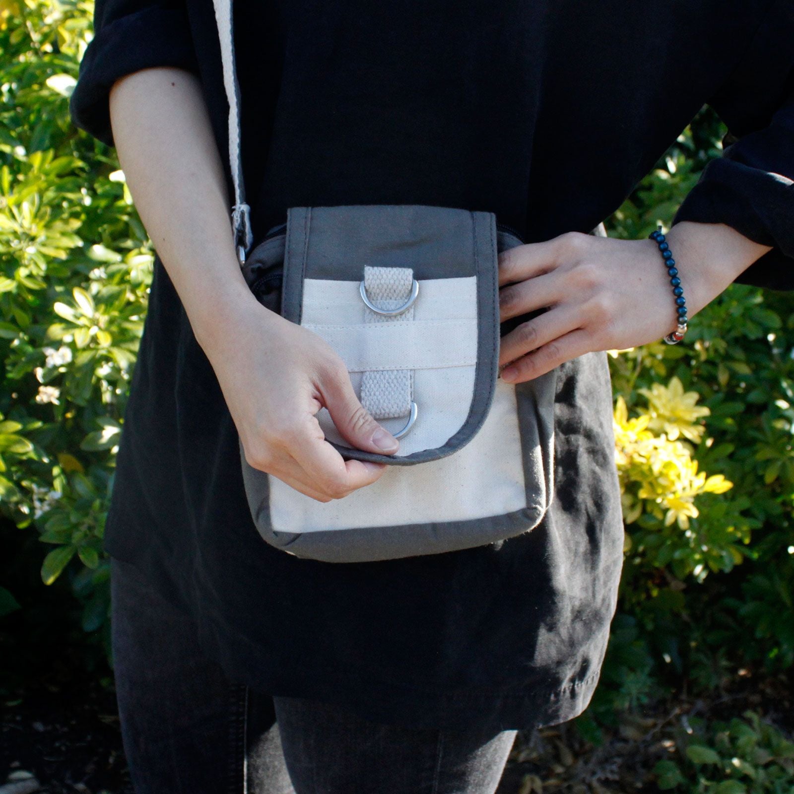 Handmade charcoal grey natural cotton cross body travel bag with adjustable strap and two secure zippered pockets.