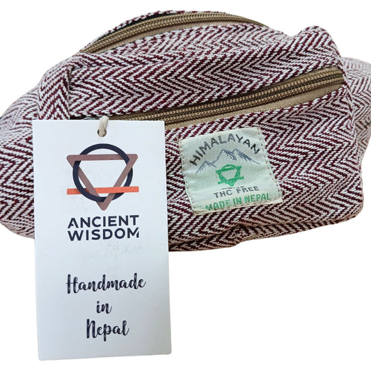 Wine-coloured cotton and hemp blend belt bag with adjustable strap and zip compartments.